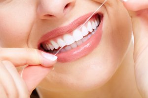 Person flossing teeth