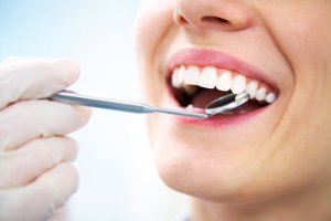 Person with dental tool in their mouth